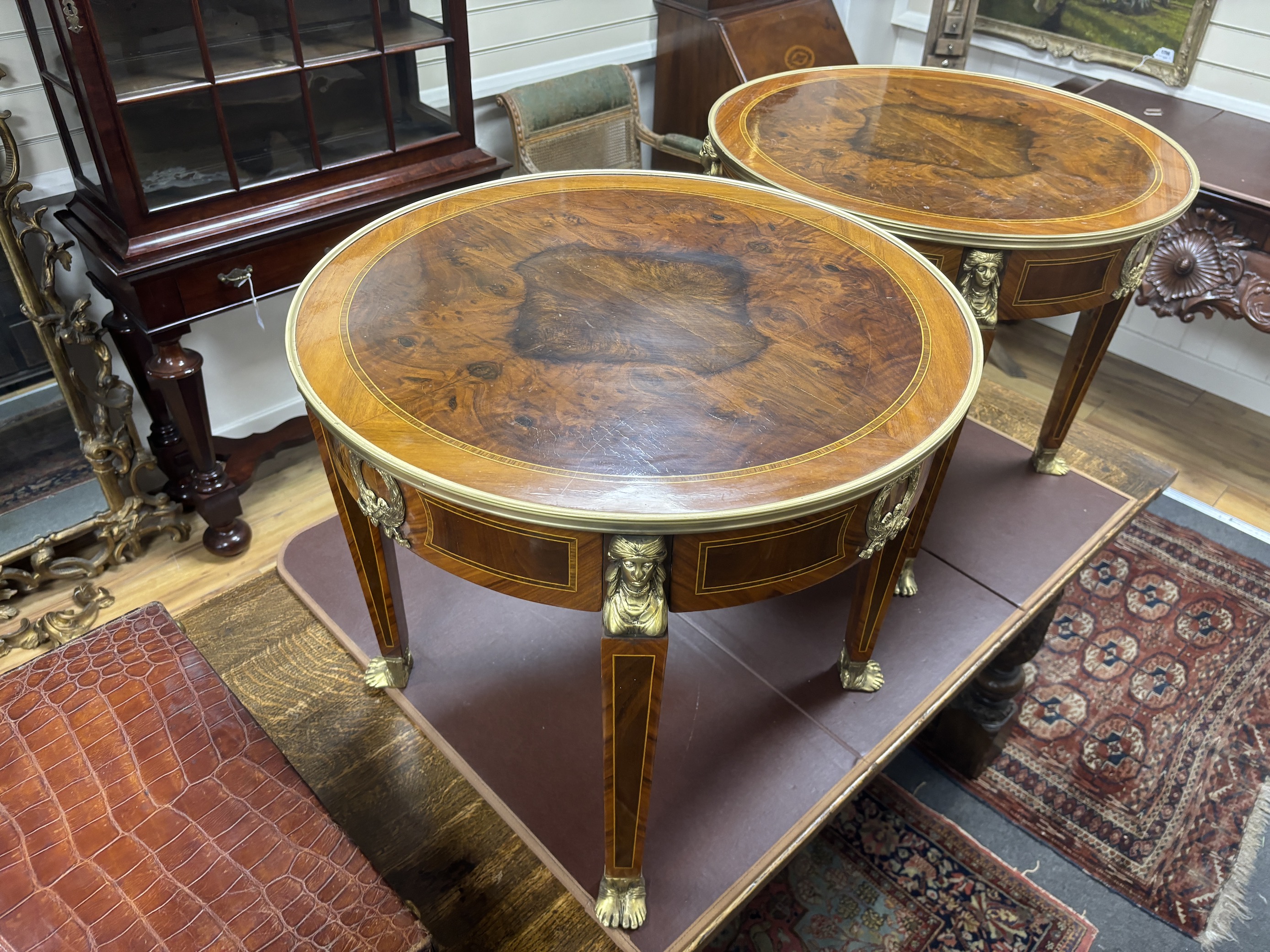A pair of Empire style circular gilt metal mounted occasional tables, diameter 61cm, height 53cm